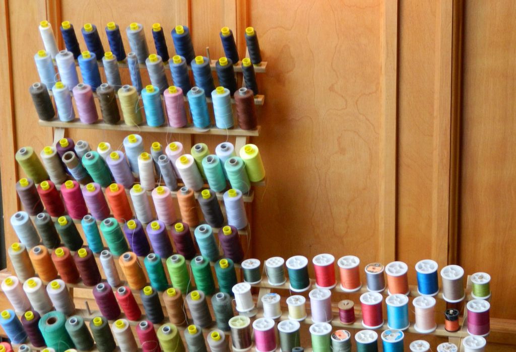 A room filled with lots of different colored spools of thread.
